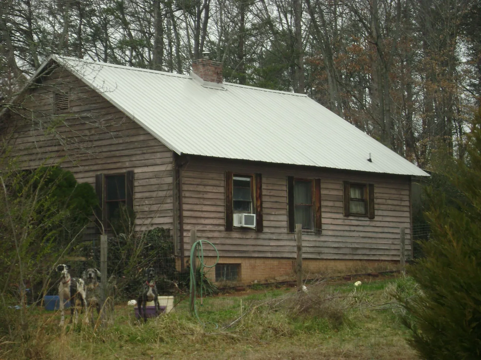 White metal roof on an old wood sided farmhouse, from a Asphalt Shingle Roof Repair job in Pewaukee
